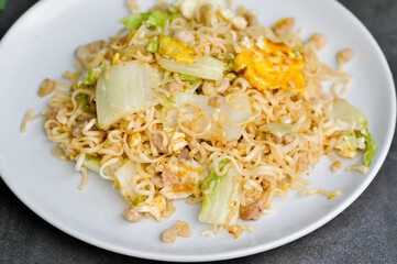 stir fried noodles with pork and vegetable in the pan