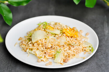 stir fried noodles with pork and vegetable in the pan