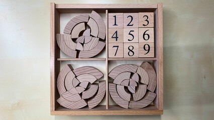 Children's educational game made of natural wood for teaching geometric shapes, counting and improving fine motor skills