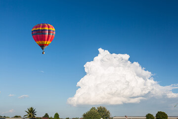 color hot air balloon in blue sky and cloud