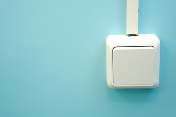 white switch on a blue wall in the interior