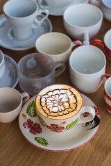 art latte hot coffee cup on wooden table, drink concept 