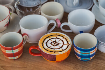art latte hot coffee cup on wooden table, drink concept 