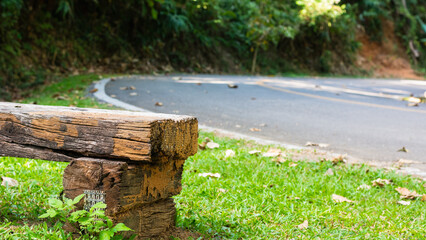 Roadside wooden bench on natural background.