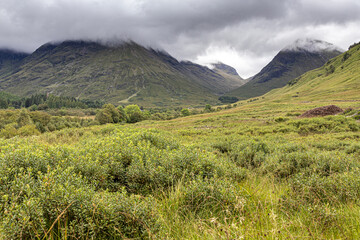 Brooding clouds hanging over the valley of Glencoe, site of the massacre in 1692, Highland, Scotland UK