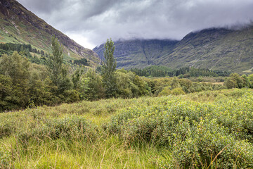 Brooding clouds hanging over the valley of Glencoe, site of the massacre in 1692, Highland, Scotland UK