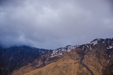 A beautiful mountain landscape with a cloudy sky. Snow-capped peak of Mount Kazbek in Stepantsminda Georgia