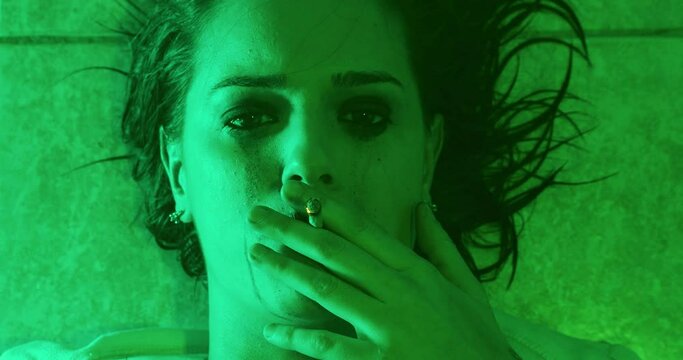 estranging oneself - depressed girl smokes marijuana to get away from reality