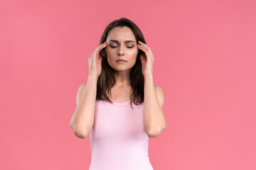 Stressed or having a headache businesswoman in suit holding her head with eyes shut isolated on...