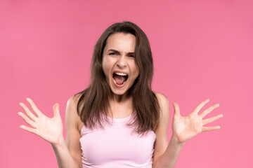 Stressed or having a headache businesswoman in suit holding her head with eyes shut isolated on pink background. Stressed employee woman in stripe suit