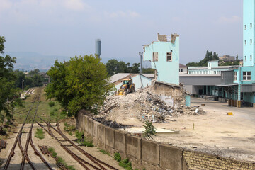 bulldozer demolishes the building