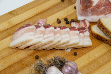 Ukrainian traditional food concept with white bread. Ukrainian raw lard with peppercorn and garlic,...