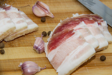 Ukrainian traditional food concept with white bread. Ukrainian raw lard with peppercorn and garlic,...