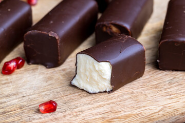 dessert of creamy filling and chocolate on a board