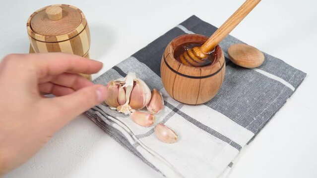 Fermented garlic cloves honey, a rich source of probiotics, white background