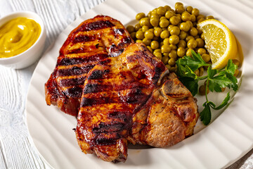 grilled pork t-bone steaks with boiled green peas