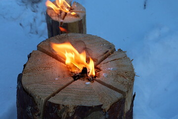 Swedish torch, burning wood, winter campfire, 