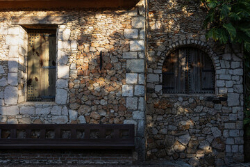 two windows of different shapes on the ancient wall. Rectangular and semicircular window in medieval house
