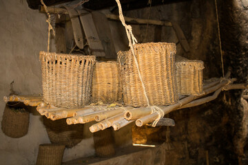 evocative image of baskets placed on a bamboo shelf
of a peasant house in southern Italy