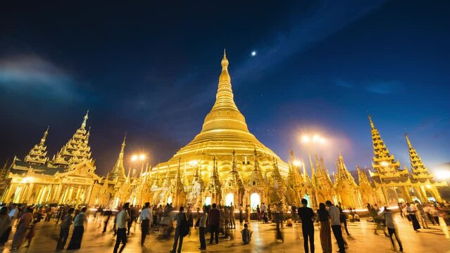 Time lapse view of historical landmark Shwedagon Pagoda Buddhist temple at night in Yangon, Myanmar (Burma).	