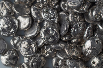 Rose alloy for soldering, silver background closeup view.