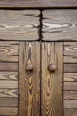 The texture of the facade of a wooden cabinet close-up.