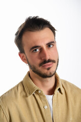 Obraz premium Closeup of a portrait of a young Caucasian man with serious expression and deep blue eyes look