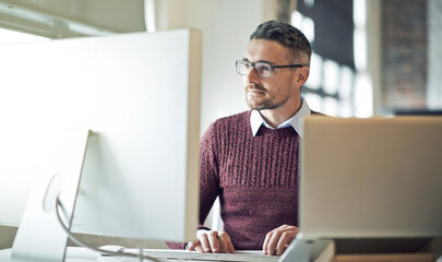 Keeping up with the changes in technology and styles. Cropped shot of a businessman working on his...