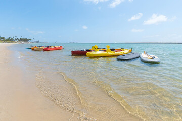 Kayaks at Muro Alto beach, tourist attraction of this famous beach of Ipojuca. Beach with no waves, warm and calm water surrounded by a reef wall.