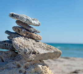 Pyramid of stones on the seashore. Beach. Relax. Horizon. Meditation. Thoughts about God and about yourself.
