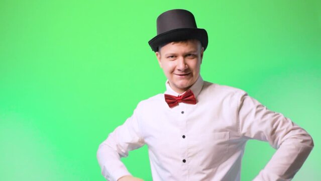young man in a hat and bowtie glasses happy performer chromakey . suit
