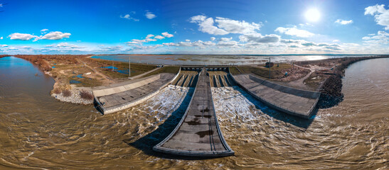 The spillway of the Shapshug reservoir into the Kuban river -  aerial  panorama on a winter sunny day - obrazy, fototapety, plakaty