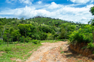 Obraz premium Beautiful landscape on the farm with trees, blue sky, mountains and clouds