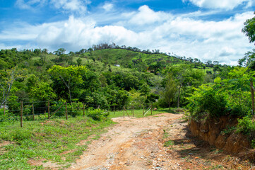 Fototapeta na wymiar Beautiful landscape on the farm with trees, blue sky, mountains and clouds