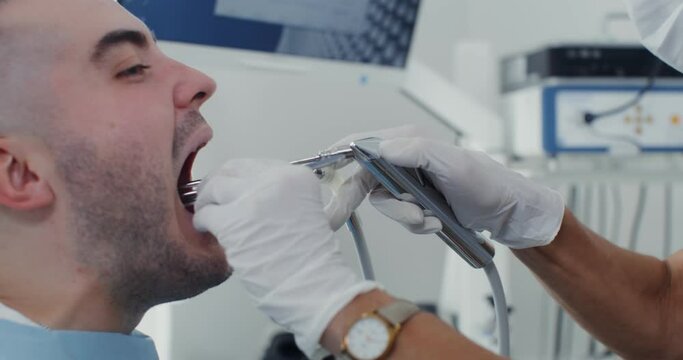 Examination of the larynx of a male patient with the help of medical instruments