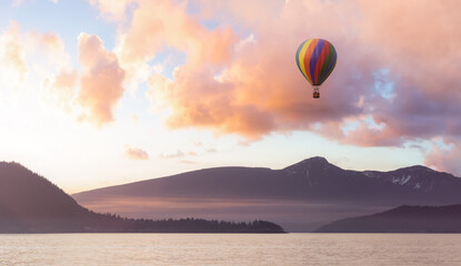 Fototapeta na wymiar Hot Air Balloon flying over Canadian Mountain Nature Landscape on the Pacific West Coast. Cloudy Colorful Winter Sunset. 3d Rendering aircraft Adventure Concept. Howe Sound, British Columbia, Canada.