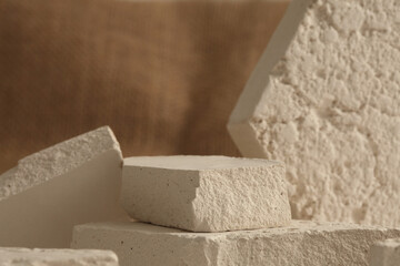 Empty eco stack of stones platform podium on beige background. Minimal empty display product presentation scene.