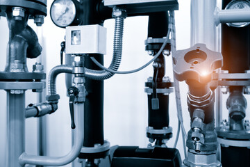 Industrial  concept. equipment of the boiler-house, - valves, tubes, pressure gauges, thermometer. Close up of manometer, pipe, flow meter, water pumps and valves of heating system in a boiler room.