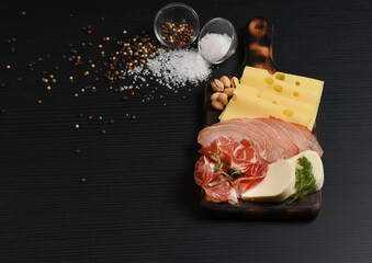 Antipasto board with sliced meat, ham, salami, different cheese. Top view with copy space.