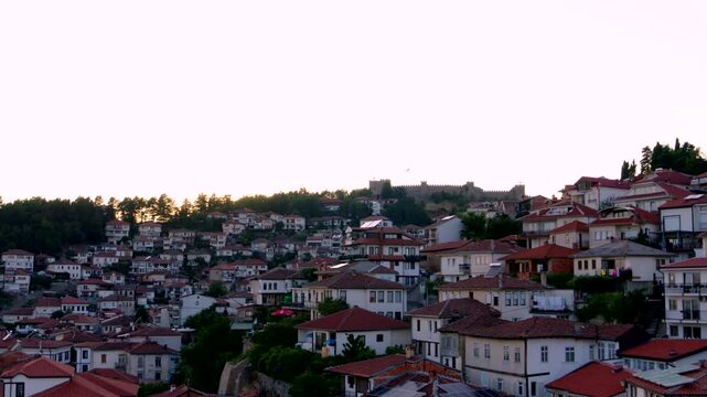 Flying above Ohrid houses - Aerial establishing shot at sunset Samoil's Fortress Ohrid North Macedonia