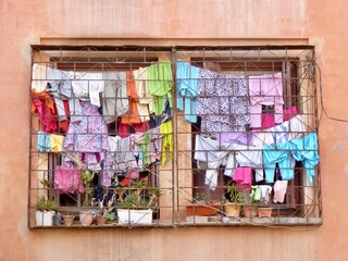 Laundry day in Marrakech, colorful clothes hanging outside the window. Morocco.