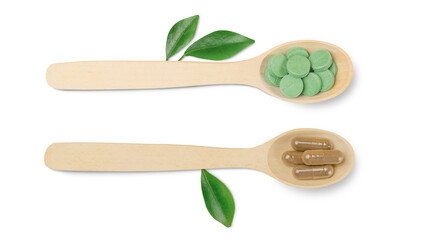 Isolated two wooden spoons with natural capsules on a white background. Alternative medicine concept