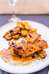 High view of some delicious baked chicken legs with rustic potatoes and some delicious boletus sauteed in EVOO and Spanish paprika.