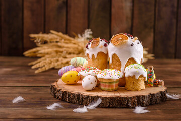 Festive cakes with white glaze, nuts and raisins on the festive table