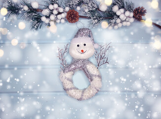 christmas snowman toy with fir branches decor and snow