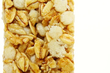 tasty granola oats bar closeup on white background with copy space