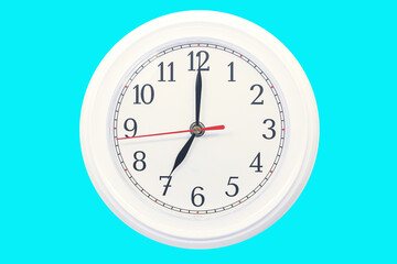 Wall mounted white dial clock isolated on a blue background