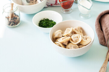 Homemade Meat Dumplings - russian traditional plate pelmeni, stuffed with minced beef  serving in a white bowl.