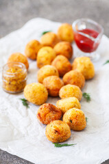 Deep fried savory potato cheese balls on a baking paper. Close up. - 488053688