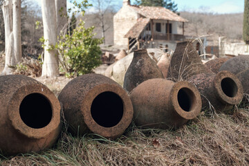 Group of Georgian traditional ancient jugs for wine on the field with blurred background